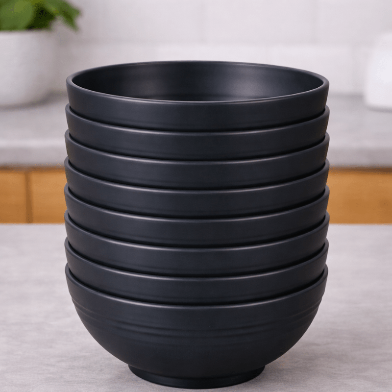 Stack of Midnight Slate straw bowls on a neutral background