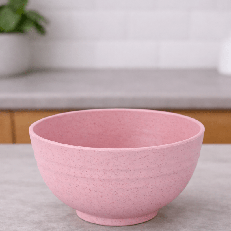 Pink wheat straw cereal bowl on a neutral background