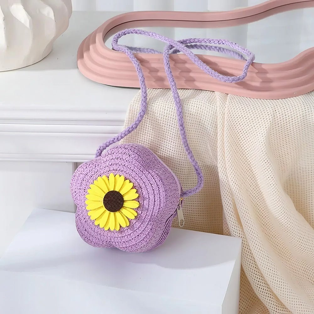 Purple woven bag with a yellow flower on a white surface
