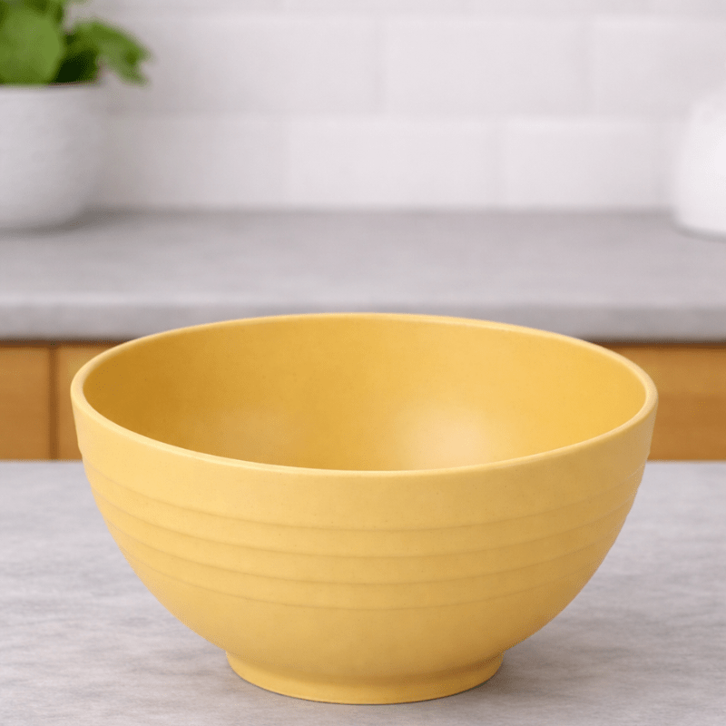 Yellow wheat straw cereal bowl on a neutral background