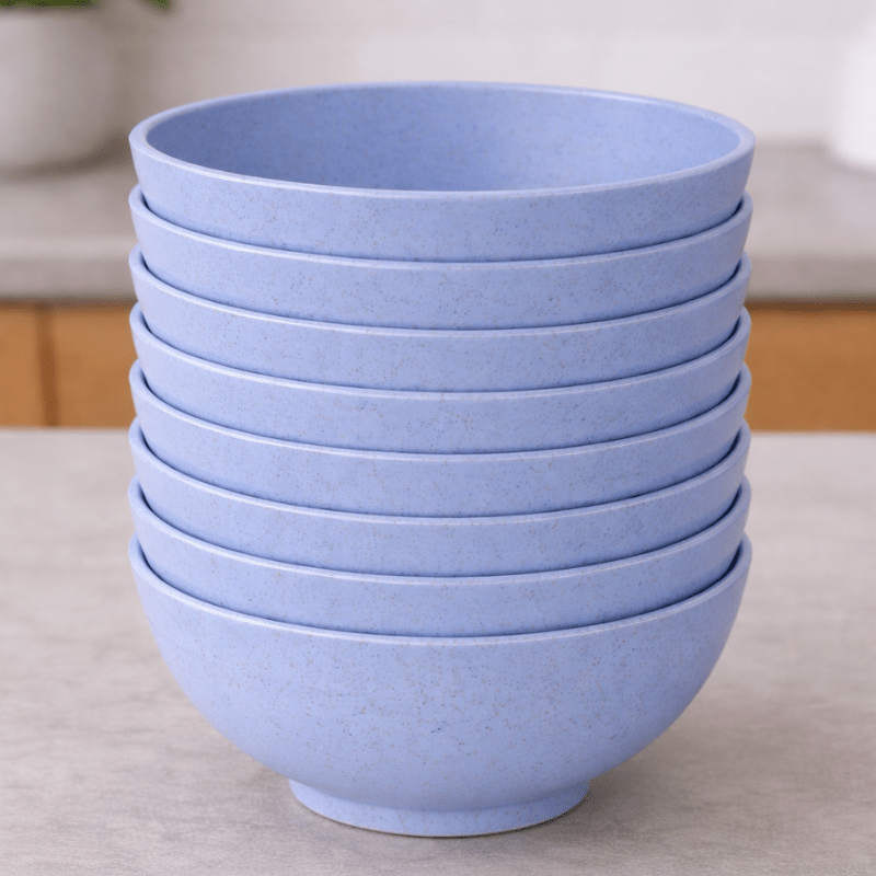 Stack of light blue straw bowls on a neutral background